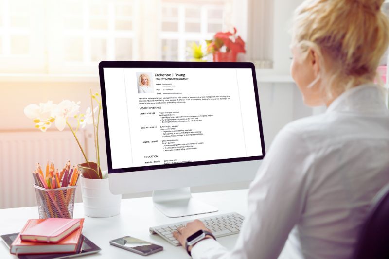 person looking at CV on a laptop